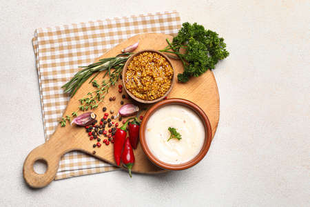 Bowl with lard spread and spices on white background