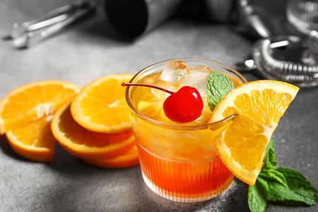 Glass of cold Tequila Sunrise cocktail on table