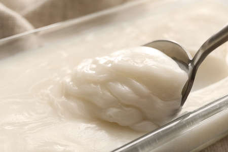 Baking dish of lard spread and spoon on table, closeupの写真素材