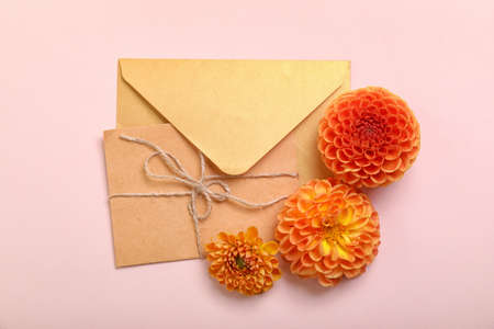 Envelopes and dahlia flowers on color backgroundの写真素材