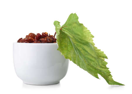 Bowl with tasty dried raisins on white backgroundの写真素材