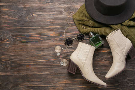 Trendy female accessories and perfume bottle on wooden backgroundの写真素材