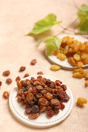 Stand with tasty raisins on color background