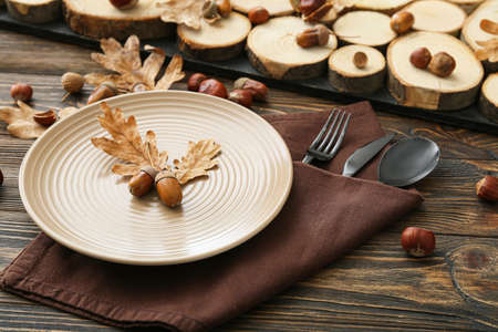 Stylish autumn table setting on wooden background