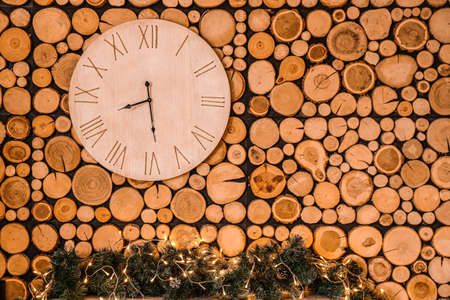 Christmas fairy time. Clock hanging on wooden wall in room.の写真素材