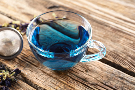 Cup of butterfly pea flower tea on tableの写真素材