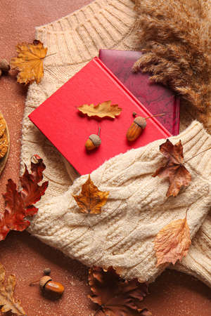 Books, warm sweater and autumn decor on grunge backgroundの写真素材