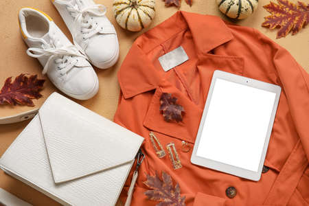 Stylish female accessories, autumn decor and tablet computer on beige background. black friday saleの写真素材