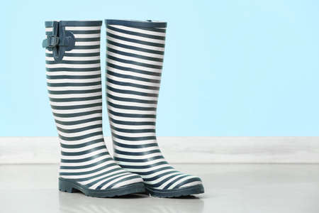 Rubber rain boots near color wallの写真素材