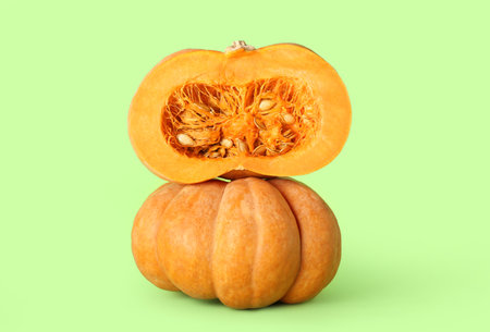 Ripe tasty pumpkins on color backgroundの写真素材