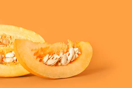 Ripe cut pumpkin on color backgroundの写真素材