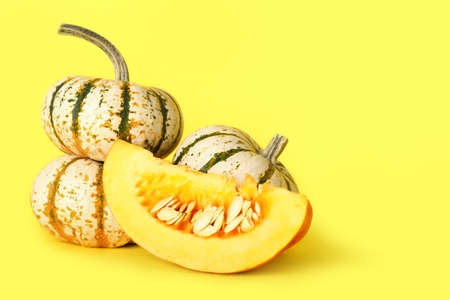 Ripe tasty pumpkins on color background