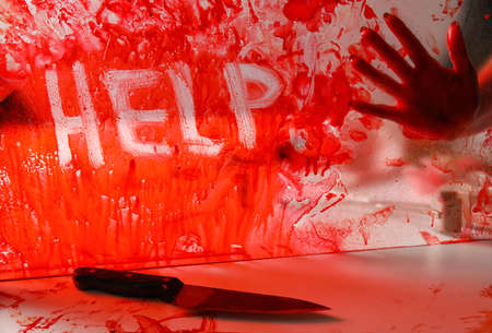 Word HELP written on bloodstained glassの写真素材