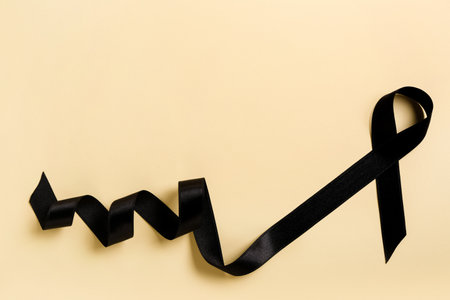 Black satin ribbon on color background. melanoma conceptの写真素材