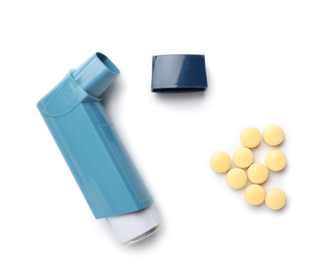 Modern asthma inhaler and pills on white backgroundの写真素材