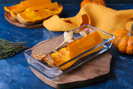 Dish with baked pumpkin piece on blue backgroundの写真素材
