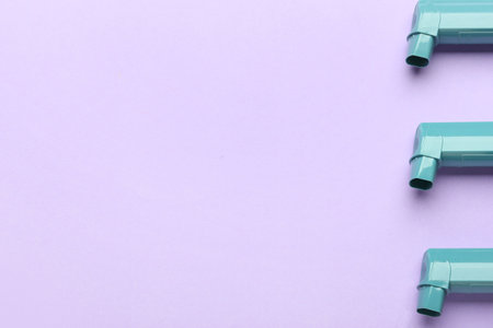 Asthma inhalers on color background