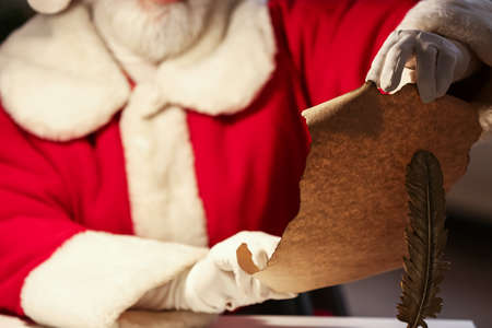 Santa Claus reading wish list at home on Christmas eveの写真素材