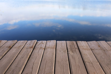 wooden pier on calm water backgroundの写真素材