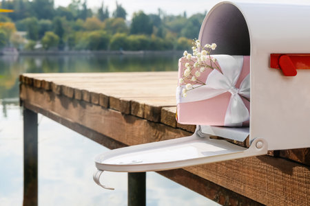 Mailbox with gift on pier near riverの写真素材