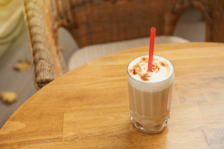 Glass of tasty coffee on table in outdoor cafeの写真素材