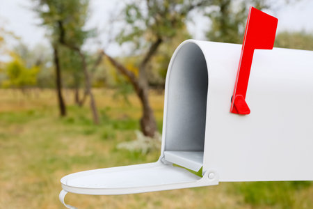 Open white mailbox in autumn parkの写真素材