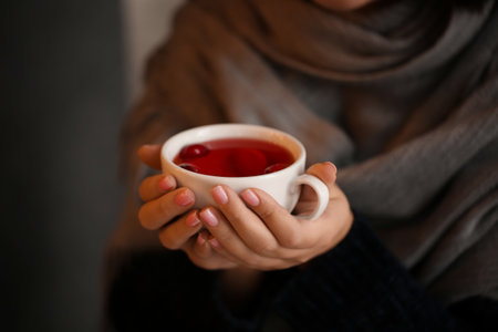 Young woman drinking tea in cafe, closeupの写真素材
