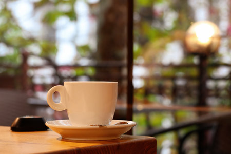 Cup of hot tea on table in cafeの写真素材