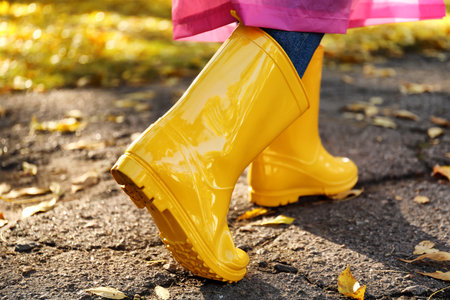 Young woman in gumboots outdoors on autumn dayの写真素材