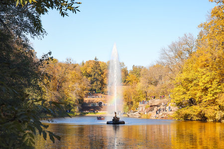 Pond with beautiful fountain in autumn parkの写真素材