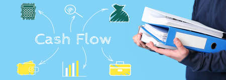 Man with folders and text CASH FLOW on light blue backgroundの写真素材