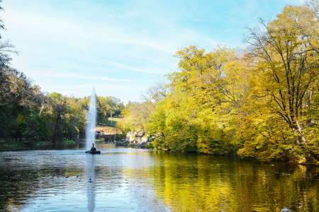 Beautiful view of lake with fountain in autumn park