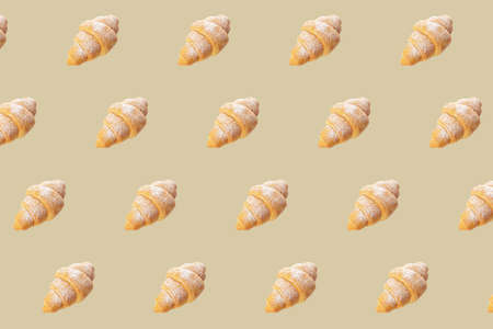 Many fresh croissants on beige background. pattern for designの写真素材