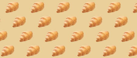 Many fresh croissants on beige background. pattern for design