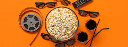 Composition with popcorn, cola and 3D glasses on orange background, top viewの写真素材