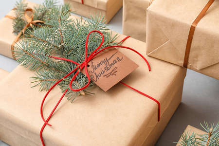 Christmas present with fir branches on light backgroundの写真素材