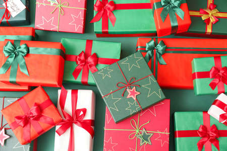 Different Christmas presents on color background
