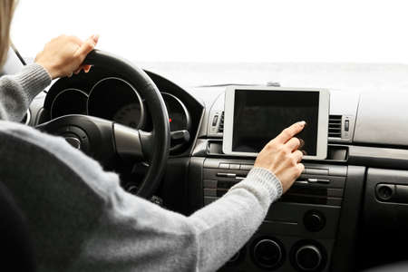 Female driver using tablet computer for navigation