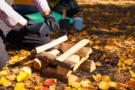 Male tourist with firewood in the forest