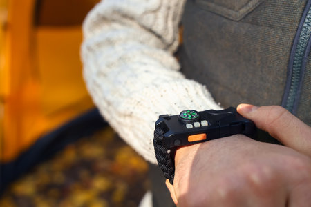 Male tourist with compass in forest, closeup