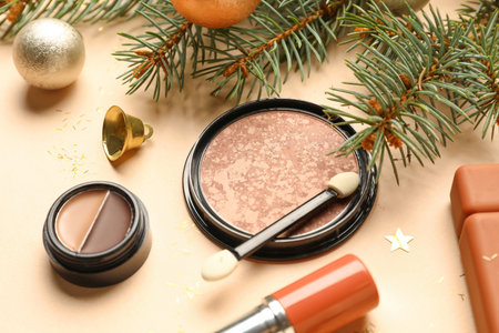 Decorative cosmetics, fir tree branch and Christmas decor on color background, closeupの写真素材