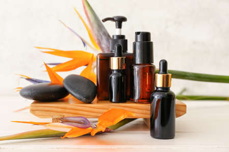Composition with different cosmetic products and strelitzia flowers on light backgroundの写真素材