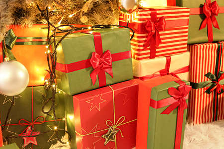 Many gift boxes under Christmas tree in living room