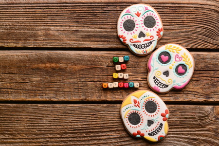 Skull shaped cookies for Mexico's Day of the Dead (El Dia de Muertos) on wooden backgroundの写真素材