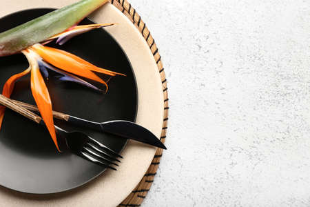 Simple table setting with bird of paradise flower on light grunge backgroundの写真素材