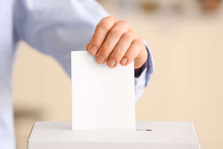 Voting man near ballot box