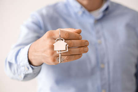 Man holding key from house, closeupの写真素材