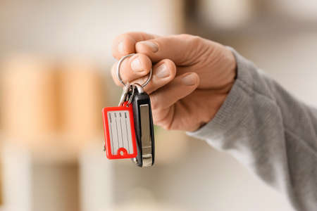 Male hand holding keys on chain