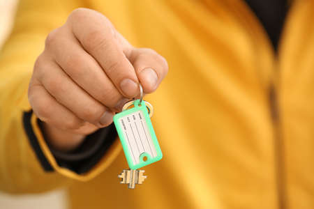 Man holding key on chain, closeupの写真素材