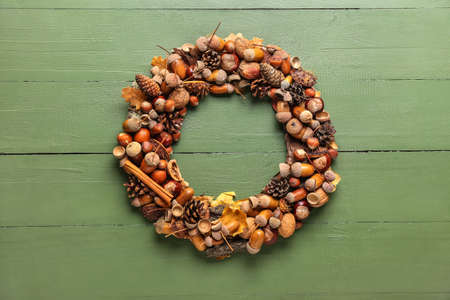 Beautiful acorn wreath on green wooden backgroundの写真素材